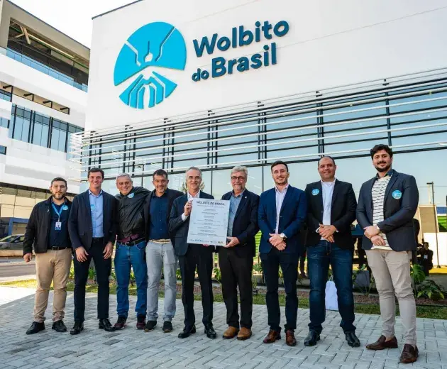 Members of Wolbito do Brasil and World Mosquito Program standing in front of new mosquito factory in Curitiba