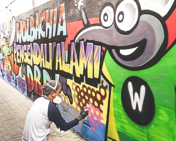 Andri painting the WMP mural