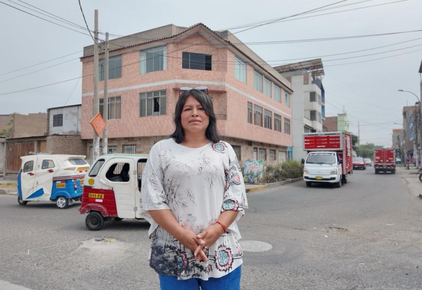 community volunteer, Alicia, standing in the street in Comas, Peru