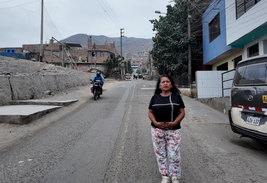 Carmen in street with world mosquito program volunteer in background